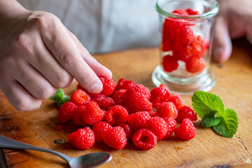 Fresh raspberries on wooden board.
