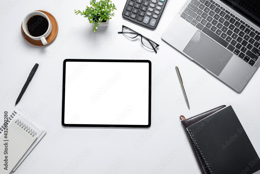 Poster digital tablet blank white screen with lots of tech gadgets placed on white table top view. mock up.