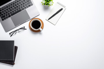 Workspace with keyboard coffee mug notebook in flat lay style. White background. Top view.