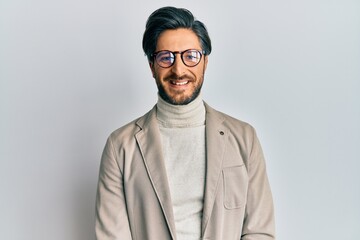 Fototapeta premium Young hispanic man wearing business jacket and glasses with a happy and cool smile on face. lucky person.