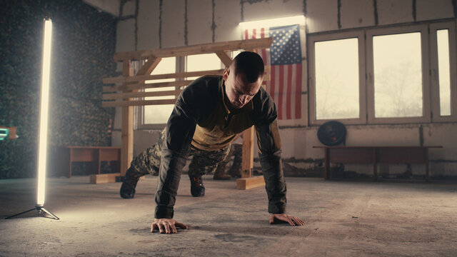 Male soldier doing push ups and taking break