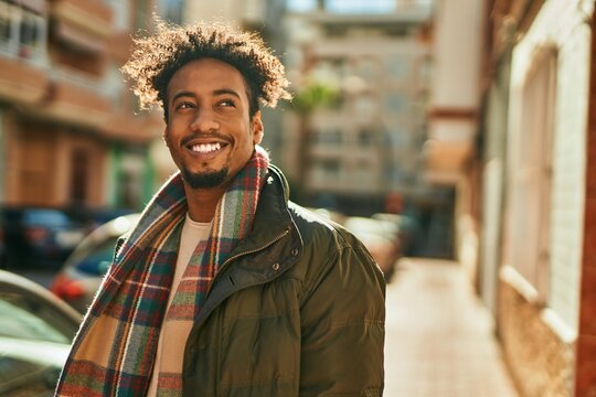 Young african american man smiling happy standing at the city
