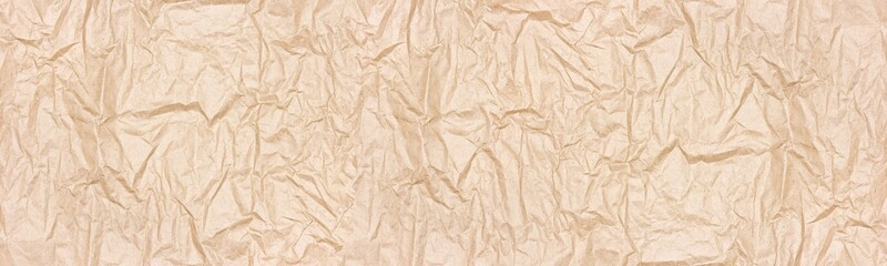 Fototapeta premium Crumpled kraft packing paper wide texture. Wrinkled recycled brown paper sheet widescreen backdrop. Large abstract banner background