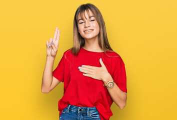 Teenager caucasian girl wearing casual red t shirt smiling swearing with hand on chest and fingers...
