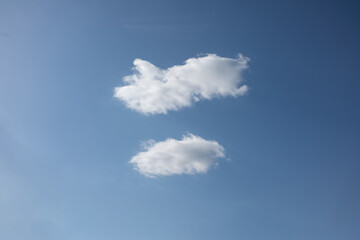 Blue sky and two clouds