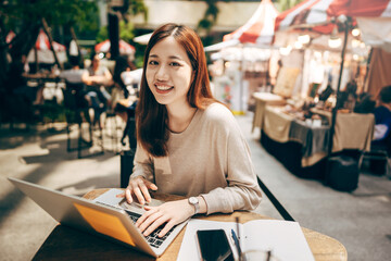 Business freelancer adult asian woman using laptop computer work via internet technology.