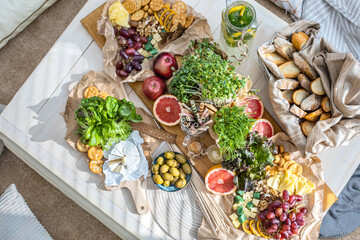 Top view cosiness lounge interior with serving table ready for party celebrating hygge boho scandi
