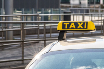 Taxi with yellow sign on roof on a shiny day waiting for passengers and tourists to drive to...