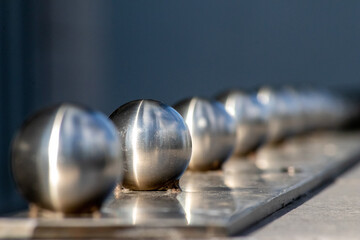 Matt steel balls in a row as decorative and ornamental balustrade and futuristic fence design with...