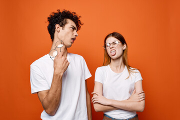 cheerful young couple in white t-shirts wearing glasses emotions