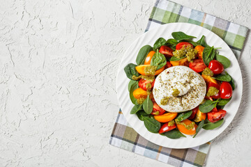Spinach, Tomato and Burrata Salad on a plate