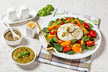 Spinach, Tomato and Burrata Salad on a plate
