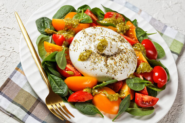 Spinach, Tomato and Burrata Salad on a plate