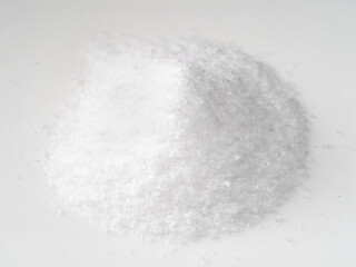 pile of finely ground sea salt closeup on white