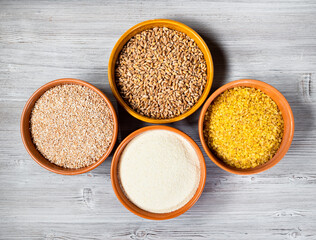 uncooked wheat groats in round ceramic bowls