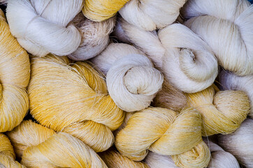 Bundle of raw white and silk thread ready for fabric production