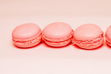 French pink macaroon cookies on silk tablecloth