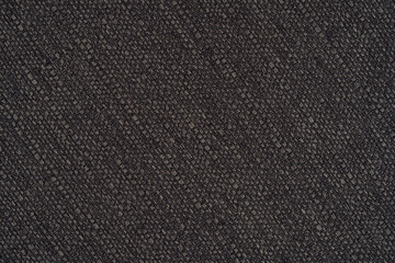 Structure of black fabric as pattern backdrop. Dark grey background from textile material with wicker texture.