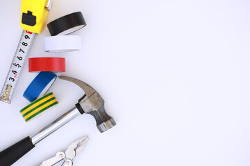 Top view of Set of construction and maintenance tooling for handyman on white concrete background with copy space
