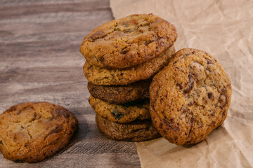 Homemade wholegrain cookies with oatmeal, lin and sesame seeds on dark rustic wooden table, copy space. Healthy vegan wholegrain cookies.