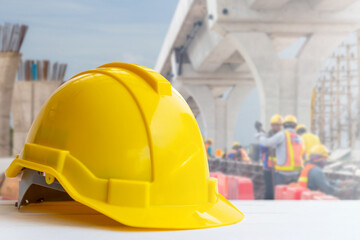 Yellow safety helmet with clipping path blurred construction site background