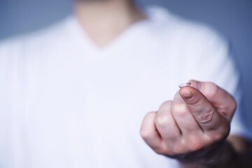 The concept of poor vision. Hold a contact lens and glasses in hand. A poster for advertising...