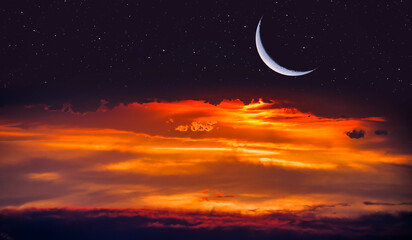 Obraz na płótnie Canvas Ramadan Kareem background -Crescent moon and stars at amazing sunset 