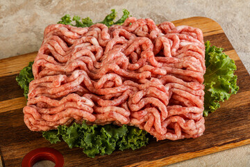 Raw pork minced meat over board