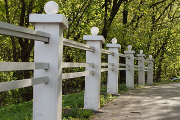White wooden fence on the path in the park