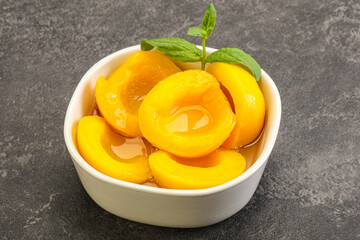 Sweet ripe canned peaches with mint