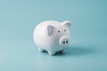 White piggy bank saving on blue background , Financial and money deposit concept.