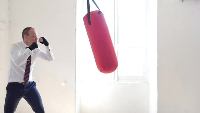 man fighting a punching ball: well dressed sales person standing and boxing with gloves. Businessman fighting hard business future. angry businessman in boxing gloves determined to win. facing fears