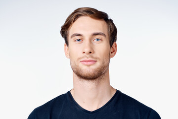 Fototapeta premium portrait of a handsome man in a blue t-shirt close-up model tattoo
