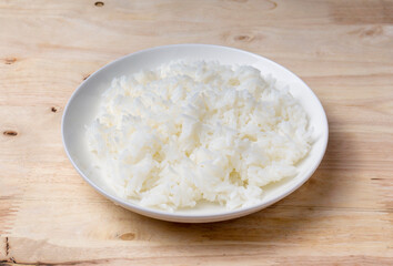 Close up steamed jasmine rice on wooden table.