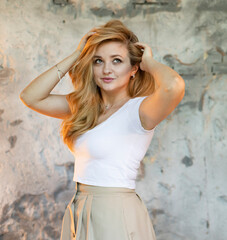 portrait of a young beautiful  woman on a wall background 
