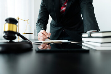 Lawyer or judge standing holding a pen to write legal documents