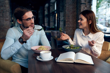 business man and woman breakfast in a cafe communication work colleagues