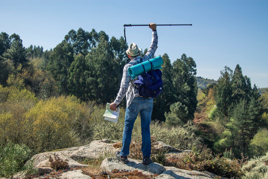 man traveling with backpack and map hiking