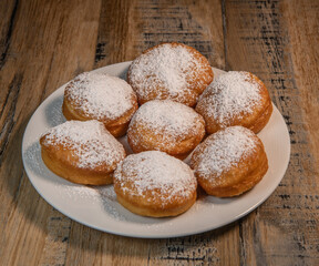 Freshly cooked Apricot jam doughnuts, referred to as jelly doughnuts, donuts in the US, The doughnuts have been fried, injected with a generous amount of jelly, jam and then dipped in caster sugar