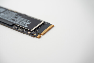 Close-up of a solid-state hard drive with an m2 interface on a white background. Selective focus, copy space