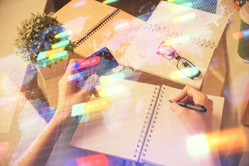 Double exposure of woman on-line shopping holding a credit card and data theme hologram drawing. E-commerce concept.