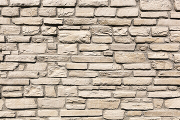 Off white brick stone wall, different size bricks, textured 