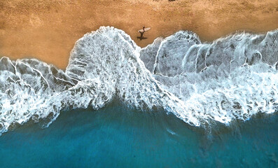 AERIAL, TOP DOWN: Unrecognizable surfer walking along the exotic sandy beach. - obrazy, fototapety, plakaty