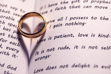 Golden wedding ring on bible book