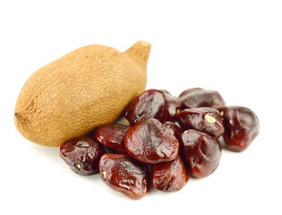 Tamarind (Tamarindus Indica) Stones (Seeds) with Fruit. Also known as Indian Dates. Isolated on White