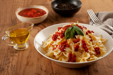 pasta with sauce on a wooden background