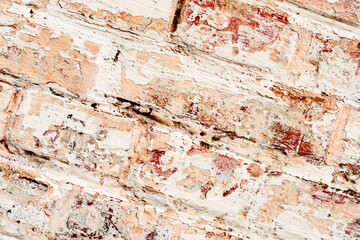 Texture of a brick wall with cracks and scratches which can be used as a background
