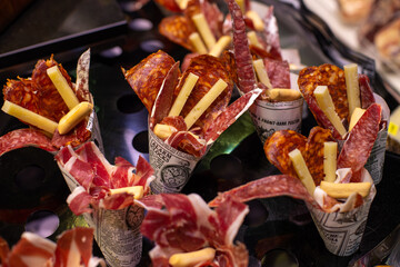 Barcelona Spain March 25 2019: Traditional Spanish meat snacks, for sale in the La Boqueria market in Barcelona, Spain.