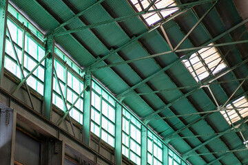 Interior view of a window with small glass panes and view on old warehouse
