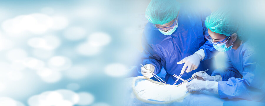 Operating Room of Surgical Table with Instruments, Assistant Picks up Instruments for Surgeons During Operation. Surgery in Progress. Professional Medical Doctors Performing Surgery.